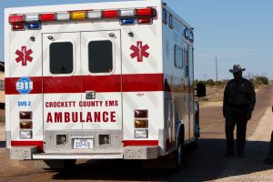 Eldorado - An ambulance makes its way through a roadblock manned by Texas State Trooper Martin Molotsky on road CR-300, which leads to the FLDS YFZ 