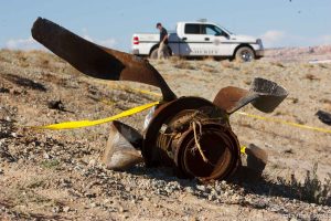 A Grand County Sheriff's Deputy stands guard at the crash site of a small plane that killed ten near the Canyonlands airport north of Moab Saturday, August 23, 2008.