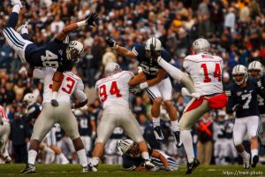 Provo - BYU LB Michael Alisa (48) flies over New Mexico's Kevin Balogun trying to block a punt by New Mexico's Adam Miller. BYU DB Jordan Pendleton (27) and New Mexico's Jeremiah Lovato (94) also in the play. BYU vs. New Mexico college football at LaVell Edwards Stadium, Saturday, October 11, 2008.