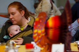 Salt Lake City - Melissa Wilson of West Jordan kisses her 5-month old daughter Kalya McBride at an early Thanksgiving. A large number of homeless and low-income individuals were served an early Thanksgiving feast at the Rescue Mission Tuesday November 25, 2008. In addition to a turkey dinner with apple, pecan, cherry and pumpkin pie, there were free flu shots, free haircuts and free backpacks. Tuesday November 25, 2008.