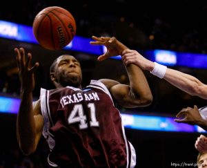 Philadelphia - BYU vs. Texas A&M college basketball, first round NCAA Division I Men's Basketball Championship at the Wachovia Center Thursday March 19, 2009. 
Brigham Young guard Lee Cummard (30) grabs Texas A&M's Chinemelu Elonu (41)
