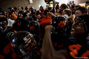 Ogden's John Rancifer (right) lets out a yell as the team comes together around coach Eric Eyre in the locker room before the game. Ogden vs. Logan High School football Friday, September 18 2009 in Ogden.