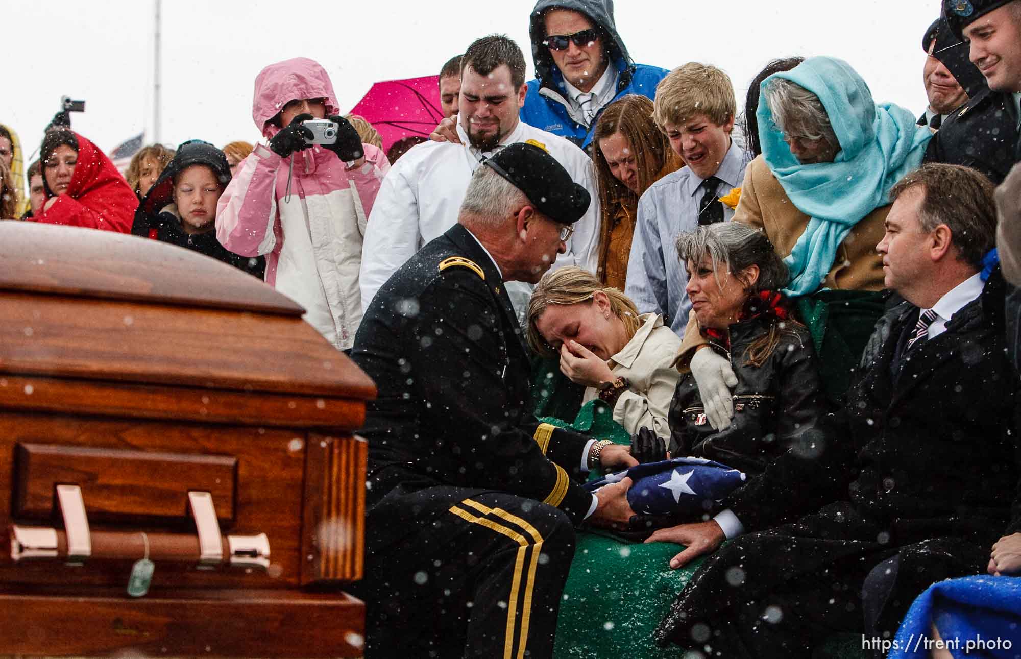 Major General Robert Williams presents a flag to Teena Nemelka, mother of Aaron Nemelka, who was killed in the Ft. Hood massacre and laid to rest at the Utah Veterans Memorial Park, Saturday, November 14 2009. Left of Teena is Aaron's sister-in-law Lindsey Nemelka, to Teena's right is her husband Michael Nemelka.