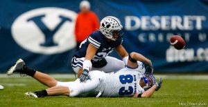 Trent Nelson  |  The Salt Lake Tribune The ball gets away from Air Force's Kevin Fogler (83), with BYU's Lee Aguirre (20) defending. BYU vs. Air Force college football Saturday, November 21 2009.
