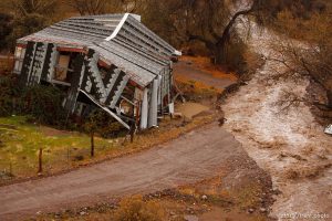 Trent Nelson  |  The Salt Lake Tribune A road in Motoqua, Utah, washed out by high waters in Beaver Dam Wash, next to a structure damaged in the 2005 flood, Wednesday, December 22, 2010.