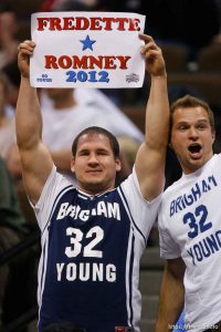 A BYU fan holds up a sign reading, 