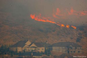 Trent Nelson  |  The Salt Lake Tribune A smoky fire burns near homes in Draper, Utah, Saturday, August 13, 2011.