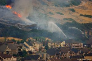 Trent Nelson  |  The Salt Lake Tribune Crews work to control a fire burning near homes in Draper, Utah, Saturday, August 13, 2011.