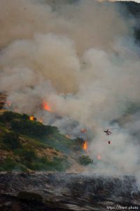 Trent Nelson  |  The Salt Lake Tribune Helicopter water drop. A smoky fire burns near homes in Draper, Utah, Saturday, August 13, 2011.