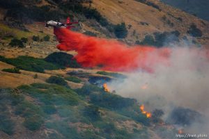 Trent Nelson  |  The Salt Lake Tribune bomber drop. A smoky fire burns near homes in Draper, Utah, Saturday, August 13, 2011.