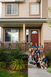 Trent Nelson  |  The Salt Lake Tribune
The Burton family on the front porch of their house Thursday, August 25, 2011. The Burton family are trying to sell their home in Tooele, Utah, due to a job transfer. Despite adding more than $20,000 in improvements since they purchased their home in 2005, they are now asking only what they paid for the home. In the back row, left to right: Scott, Angela and Kaitlyn Burton. Front row: Emily, Jeffrey, Zachary and Spencer Burton.