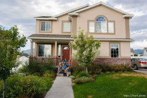 Trent Nelson  |  The Salt Lake Tribune The Burton family on the front porch of their house Thursday, August 25, 2011. The Burton family are trying to sell their home in Tooele, Utah, due to a job transfer. Despite adding more than $20,000 in improvements since they purchased their home in 2005, they are now asking only what they paid for the home. In the back row, left to right: Scott, Angela and Kaitlyn Burton. Front row: Emily, Jeffrey, Zachary and Spencer Burton.