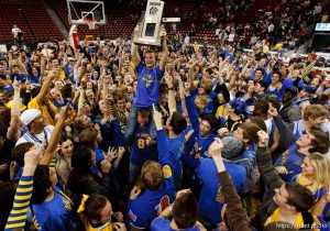Trent Nelson  |  The Salt Lake Tribune
Orem student Nate Mella held the state championship trophy aloft as Orem fans swarmed the court following their team's state championship win over Olympus. Orem vs. Olympus, 4A  high school state championship game Saturday, March 3, 2012 at the Maverik Center in West Valley City, Utah.