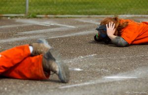 Trent Nelson  |  The Salt Lake Tribune
Weber State student Sarah Cleverley lies prone, role playing as an inmate while an emergency response team from the Chemung County (NY) Sheriff's Office moves in during a training scenario at the Mock Prison Riot, Monday, May 7, 2012 at the West Virginia Penitentiary in Moundsville, West Virginia.