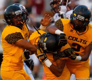 Trent Nelson  |  The Salt Lake Tribune Cottonwood's Aleni Aiono, center, celebrates his first half interception with teammates SJ Fehoko, left, and Charles Hosea as Cottonwood hosts Jordan High School football, Friday October 5, 2012.