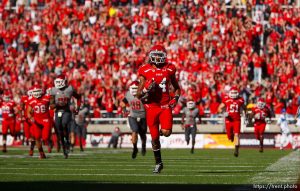 Trent Nelson  |  The Salt Lake Tribune Utah wide receiver Reggie Dunn (14) sets an NCAA record with his fourth career 100-yard touchdown return as Utah hosts Washington State, college football at Rice-Eccles Stadium Saturday November 3, 2012 in Salt Lake City.