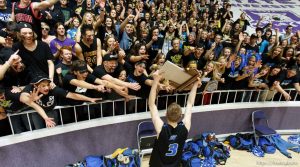 Sky View's Ty Nielsen holds the championship trophy out to fans as Sky View beats Mountain Crest High School in the 4A basketball state championship game Saturday, March 2, 2013 in Ogden.