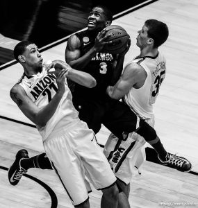 Belmont Bruins guard Kerron Johnson (3) drives between Arizona Wildcats forward Brandon Ashley (21) and Arizona Wildcats center Kaleb Tarczewski (35) as the Wildcats face the Belmont Bruins in the NCAA tournament at EnergySolutions Arena on Thursday, March 21, 2013.