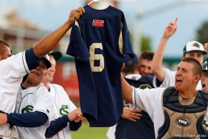 Trent Nelson  |  The Salt Lake Tribune
Snow Canyon players honored their fallen teammate Kreg “K.J.” Harrison, who drowned last year, by holding his jersey aloft following their championship win. Snow Canyon defeated Desert Hills High School for the 3A boys baseball state championship in Orem Saturday May 18, 2013.