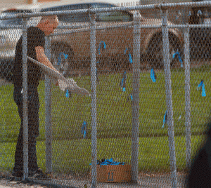 Trent Nelson  |  The Salt Lake Tribune
A man rips up a sign showing support for the Ogden Police Department and Dee Smith, which was hanging on a fence near the meeting point for marchers walking in memory of Matthew Stewart, Wednesday June 5, 2013 in Ogden.