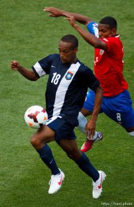 Trent Nelson  |  The Salt Lake Tribune Belize's Evral Trapp dribbles the ball with Costa Rica's Kenny Cunningham defending as Costa Rica defeats Belize 1-0 in CONCACAF Gold Cup soccer at Rio Tinto Stadium in Sandy, Saturday July 13, 2013.
