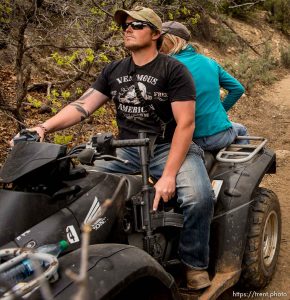 Trent Nelson  |  The Salt Lake Tribune A rider holds his finger off the trigger of his assault rifle as motorized vehicles make their way through Recapture Canyon, which has been closed to motorized use since 2007, after a call to action by San Juan County Commissioner Phil Lyman. Saturday May 10, 2014 north of Blanding.