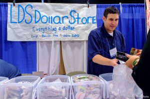 Trent Nelson  |  The Salt Lake Tribune Chris Krueger handles a transaction at the LDS Dollar Store at the first Latter-day Expo Saturday August 9, 2014 at the South Towne Expo Center in Sandy.