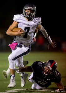 Trent Nelson  |  The Salt Lake Tribune Corner Canyon quarterback Michael Ebeling runs out of the reach of Woods Cross's Deion Saumalu as Woods Cross hosts Corner Canyon High School football, in Woods Cross, Wednesday October 15, 2014.