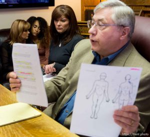 Trent Nelson  |  The Salt Lake Tribune Attorney Robert Sykes, right, and Darrien Hunt's mother Susan Hunt, center, speak at a press conference in Salt Lake City, Friday October 17, 2014. An autopsy report released Friday says Darrien Hunt was shot several times in the back by Saratoga Springs police officers chasing him. At rear is Cindy Moss (Darrien's aunt) and Aliya Hunt (Darrien's sister).