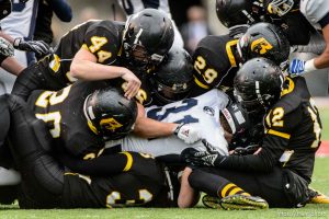 Trent Nelson  |  The Salt Lake Tribune Roy defenders bring down Corner Canyon's Cameron Forte as Corner Canyon faces Roy High School in a  4A state football semifinal game at Rice-Eccles Stadium in Salt Lake City, Friday November 14, 2014.