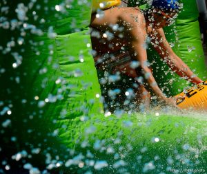Trent Nelson  |  The Salt Lake Tribune
A rider slides down Main Street on a massive slip 'n slide put up by Slide the City, in Salt Lake City, Saturday August 22, 2015.
