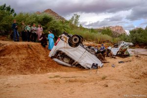 Trent Nelson  |  The Salt Lake Tribune People take in the scene in a Hildale wash where two vehicles came to rest after a flash flood that killed nine people (with four still missing) Tuesday September 15, 2015., the day after an SUV and a van were washed off a road during a flash flood in this polygamous Utah-Arizona border community.