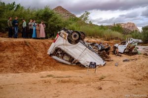 Trent Nelson  |  The Salt Lake Tribune People take in the scene in a Hildale wash where two vehicles came to rest after a flash flood that killed nine people (with four still missing) Tuesday September 15, 2015., the day after an SUV and a van were washed off a road during a flash flood in this polygamous Utah-Arizona border community.