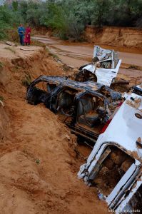 Trent Nelson  |  The Salt Lake Tribune People take in the scene in a Hildale wash where two vehicles came to rest after a flash flood that killed nine people (with four still missing) Tuesday September 15, 2015., the day after an SUV and a van were washed off a road during a flash flood in this polygamous Utah-Arizona border community.