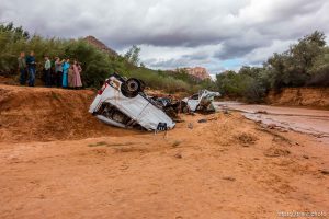 Trent Nelson  |  The Salt Lake Tribune People at the spot in a Hildale wash Tuesday September 15, 2015 where two vehicles ended up after being washed away in a flash flood. Nine people died (with four still missing) when the SUV and van were washed off a road during a flash flood in this polygamous Utah-Arizona border community.