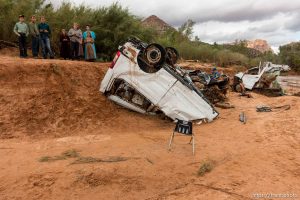 Trent Nelson  |  The Salt Lake Tribune People at the spot in a Hildale wash Tuesday September 15, 2015 where two vehicles ended up after being washed away in a flash flood. Nine people died (with four still missing) when the SUV and van were washed off a road during a flash flood in this polygamous Utah-Arizona border community.
