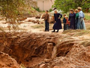 Trent Nelson  |  The Salt Lake Tribune People take in the scene in a Hildale wash where a flash flood killed nine people (with four still missing) Tuesday September 15, 2015., the day after an SUV and a van were washed off a road during a flash flood in this polygamous Utah-Arizona border community.