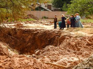 Trent Nelson  |  The Salt Lake Tribune People take in the scene in a Hildale wash where a flash flood killed nine people (with four still missing) Tuesday September 15, 2015., the day after an SUV and a van were washed off a road during a flash flood in this polygamous Utah-Arizona border community.