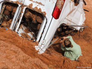 Trent Nelson  |  The Salt Lake Tribune People take in the scene in a Hildale wash where a flash flood killed nine people (with four still missing) Tuesday September 15, 2015., the day after an SUV and a van were washed off a road during a flash flood in this polygamous Utah-Arizona border community.