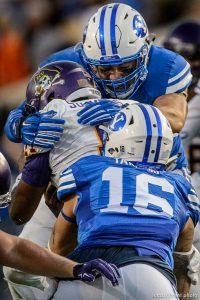 Trent Nelson  |  The Salt Lake Tribune Brigham Young Cougars defensive lineman Bronson Kaufusi (90) brings down East Carolina Quarterback Cody Keith as BYU hosts East Carolina, college football at LaVell Edwards Stadium in Provo, Saturday October 10, 2015.