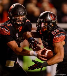 Trent Nelson  |  The Salt Lake Tribune Utah Utes quarterback Travis Wilson (7) hands off to Utah Utes running back Devontae Booker (23) as the University of Utah hosts Oregon State, NCAA football at Rice-Eccles Stadium in Salt Lake City, Saturday October 31, 2015.