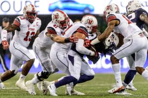 Trent Nelson  |  The Salt Lake Tribune Utah defenders bring down Washington Huskies wide receiver Chico McClatcher (13) as the University of Utah faces the University of Washington, NCAA football at Husky Stadium in Seattle, Saturday November 7, 2015. From left, Utah Utes linebacker Gionni Paul (13), Utah Utes linebacker Jared Norris (41), Utah Utes defensive end Kylie Fitts (11), McClatcher, Utah Utes defensive back Brian Allen (14).