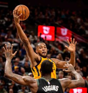Utah Jazz forward Derrick Favors (15) reaches for the ball as the Utah Jazz host the Milwaukee Bucks, NBA basketball in Salt Lake City Saturday November 25, 2017.
