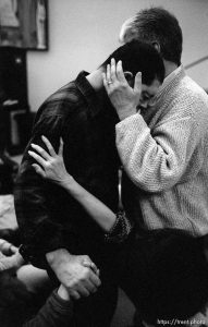 Merlyn Tapp (facing right) of Bountiful, who suffers from leukemia, is comforted and prayed for by Errol Faulkes (right) and Jean Liang (at bottom right) at a Penecostal meeting Thursday night at Judge High School.