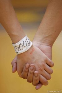 Bingham players holding hands with 