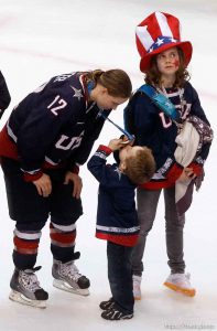 Trent Nelson  |  The Salt Lake Tribune
USA's Jenny Potter leans down for her son Cullen to kiss her silver medal. Potter's daughter Madison at right. Canada defeats Team USA in the gold medal game, women's Ice Hockey at the Canada Hockey Place, Vancouver, XXI Olympic Winter Games, Thursday, February 25, 2010.