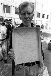 Man with protest message written on box 
