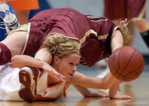 Timpview's Jessica Harmon shows the determination that brought her team to the state championship game as she dives for a loose ball underneath Mountain View's Mallary Gillespie. Utah's 4A state championship girls basketball game.
