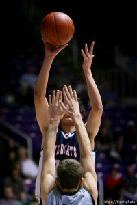 Woods Cross forward Shawn Shahan puts up a shot defended by Payson's Derek Rowley. Ogden - Woods Cross vs. Payson High School boys basketball, 4A State Basketball Championships at the Dee Events Center Wednesday.