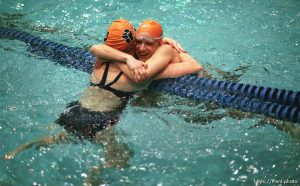 Brighton swimmers Lori Bednarchik (right) and Melissa Beutler embrace after placing 1st (LB) and 3rd (MB) at the 5A high school swimming finals.
